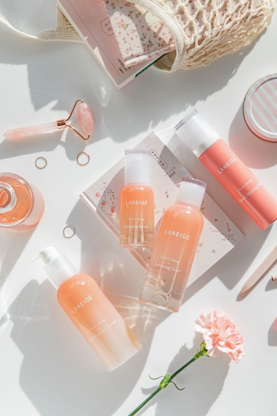 Skincare flat lay in pink tones