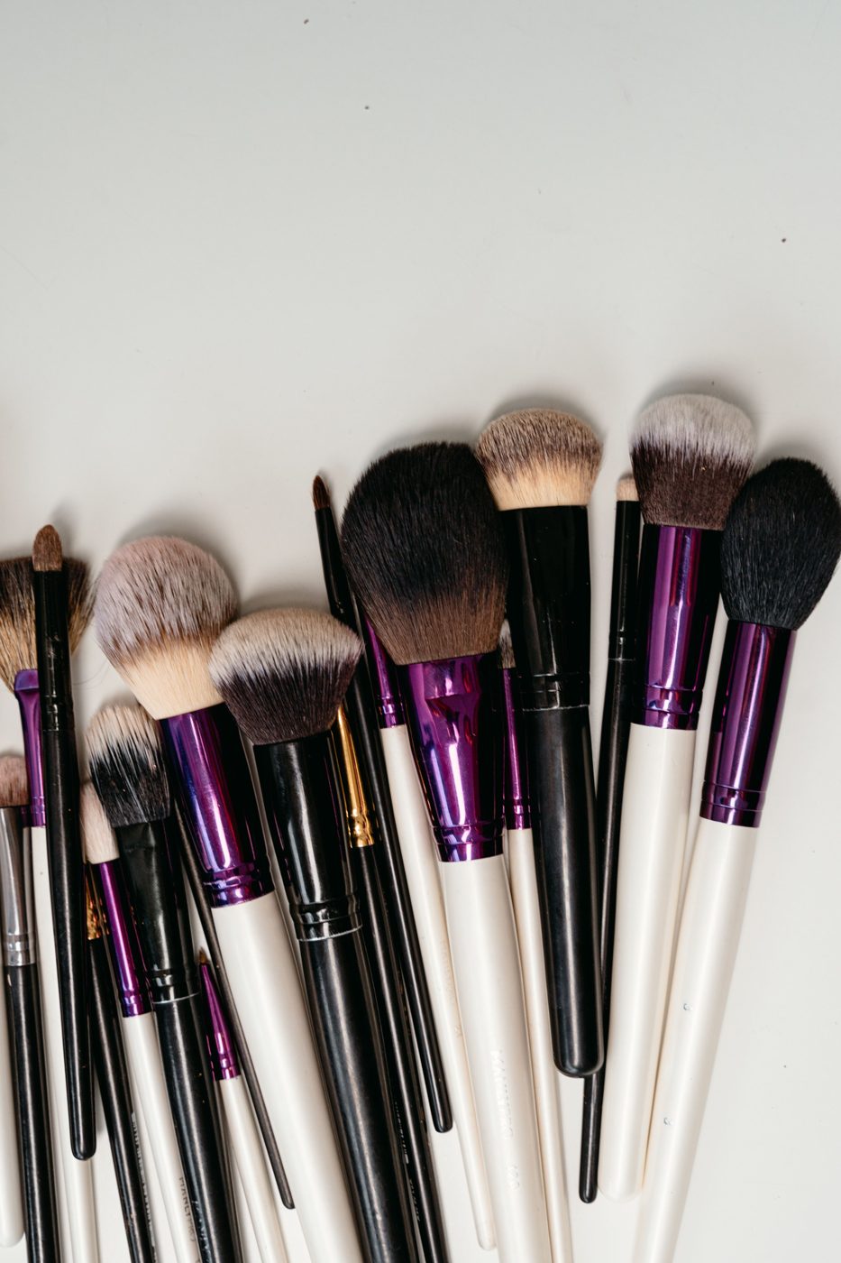 Makeup brushes fanned on a white table